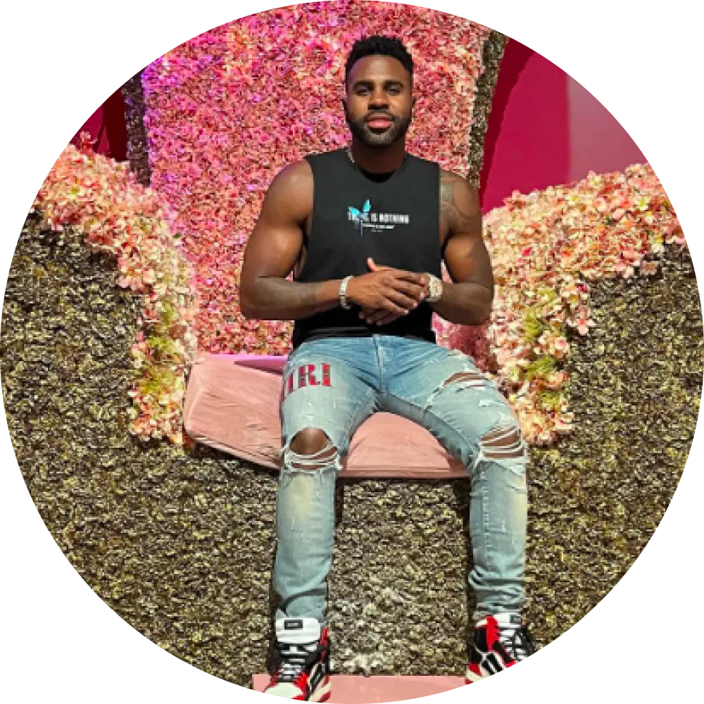 man in a sleeveless black top and ripped jeans sitting on trove big chair