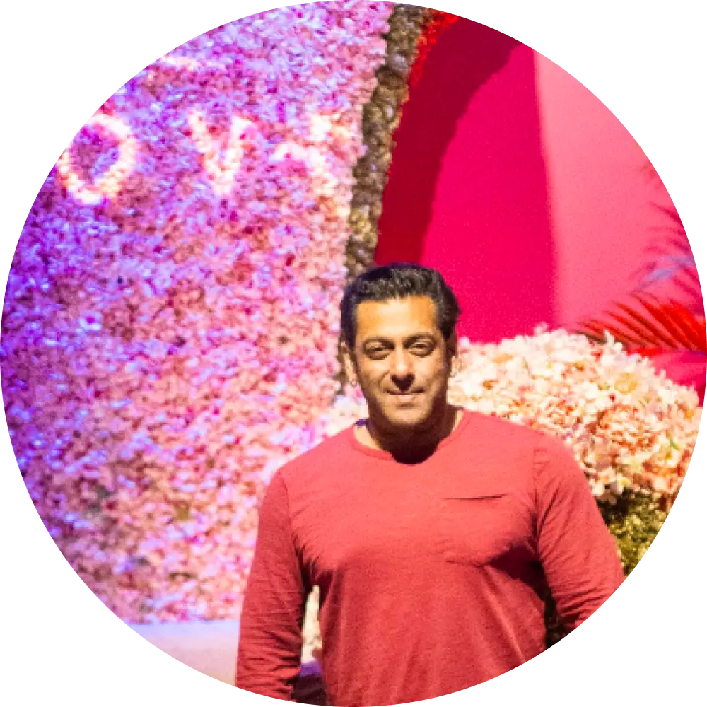 man in a red shirt posing in front of trove big chair in dubai