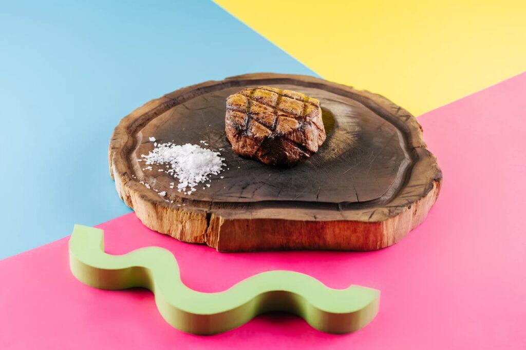 grilled beef steak in a wooden slab