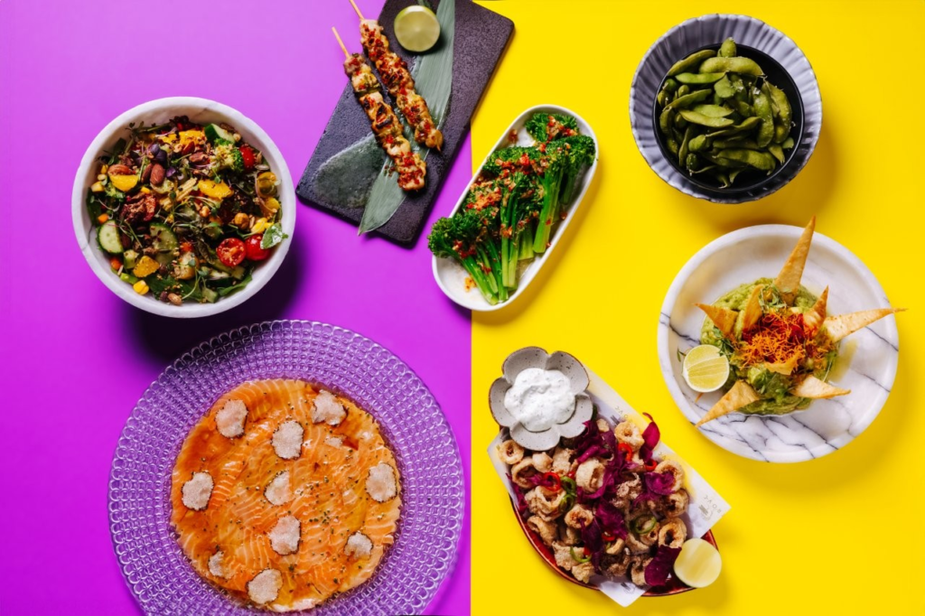 7 dishes on the table with different snacks, garnishes, and sauces