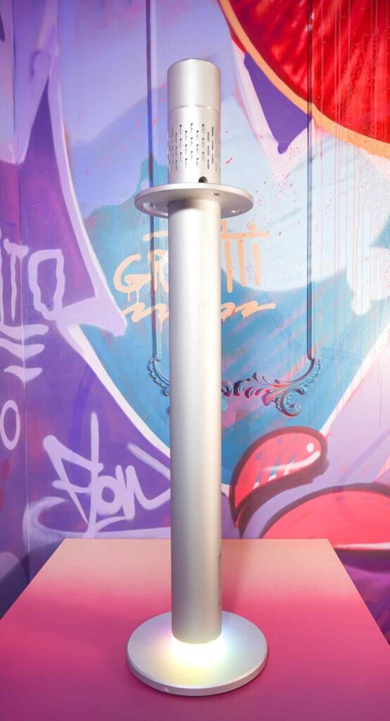 A silver shisha with colorful pink and purple background 
