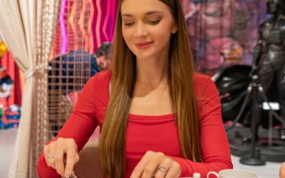 Woman enjoying a stylish brunch with plated desserts and tea in a vibrant, art-inspired restaurant setting