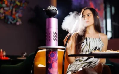 Woman enjoying shisha seated beside a vibrant hookah with food on the table