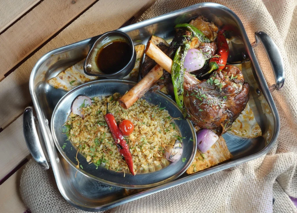 A platter full of sauces, rice, meat, and garnishes