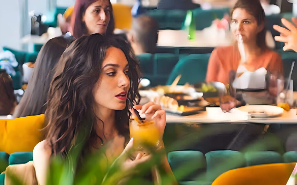 Woman dining at Trove Dubai, elegant ambiance.