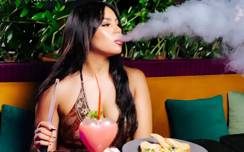 Woman enjoying luxury shisha and dining at Trove Dubai.