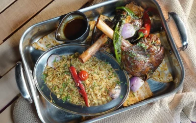 A platter full of sauces, rice, meat, and garnishes