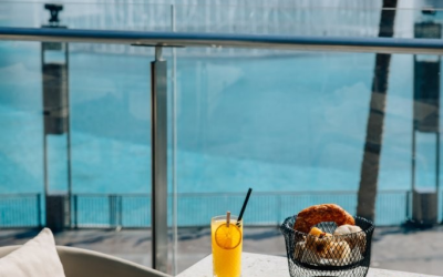 Food items on the table with a fountain in the back