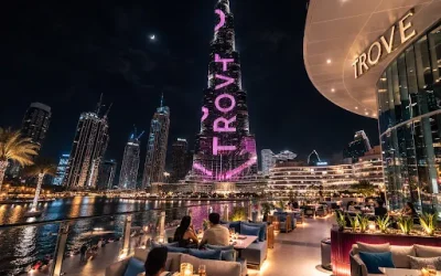 Couples dining on the Trove terrace at night with Burj Khalifa and Dubai Fountain lake views in Dubai Mall